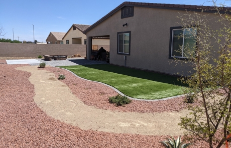 backyard-artificial-turf-with-desert-landscape.jpg Backyard design with artificial turf, desert landscaping, and stone firepit area.