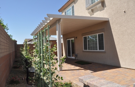 backyard-covered-patio-with-flower-trellis.jpg Backyard paver patio with covered pergola and climbing plants on trellis.
