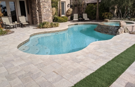 backyard-stone-paver-patio-with-lamp-posts.jpg Large stone paver patio with built-in firepit and decorative lamp posts.