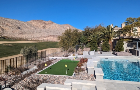 custom-pool-deck-with-stone-planters.jpg Custom pool deck with stone planters, lounge seating, and mountain backdrop.
