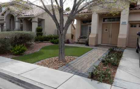 front-yard-paver-walkway-and-landscape-design.jpg Front yard with stone paver walkway, artificial turf, and desert plants.