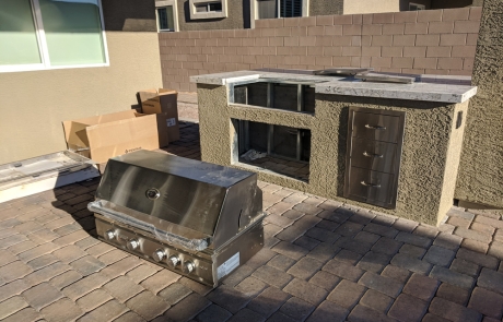 outdoor-kitchen-under-construction.jpg Outdoor stone kitchen island under construction with built-in grill installation.
