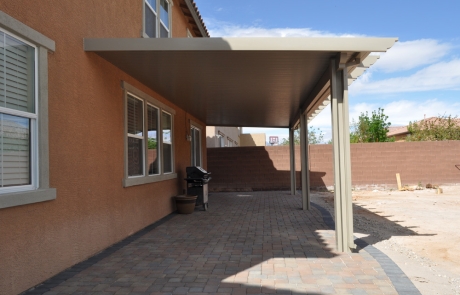 paver-patio-with-covered-pergola.jpg Wide paver patio with solid covered pergola attached to home.