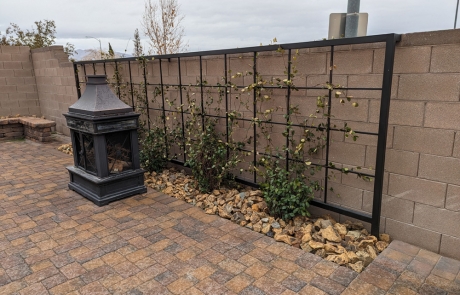 paver-patio-with-trellis-and-fireplace.jpg Backyard paver patio with trellis, stone edging, and decorative outdoor fireplace.