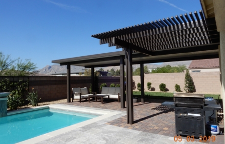 poolside-paver-patio-with-modern-pergola.jpg Poolside paver patio with modern pergola shade structure and mountain views.