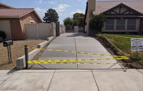 residential-concrete-driveway-construction.jpg Newly constructed residential concrete driveway with caution tape barrier.