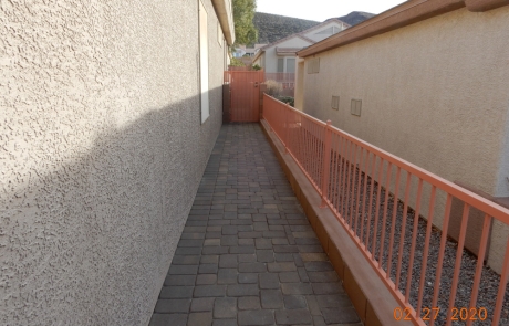 side-yard-paver-walkway-with-metal-fence.jpg Side yard with stone paver walkway and decorative metal fence.