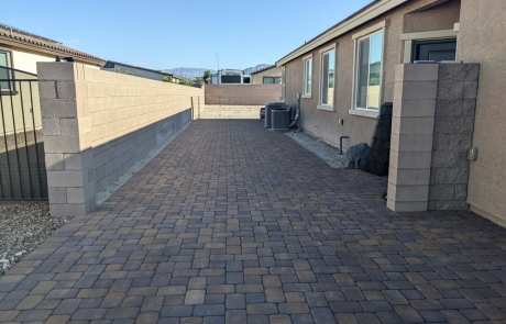 stone-paver-driveway-with-block-wall.jpg Extended stone paver driveway with block wall and desert landscape surroundings.