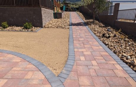 stone-retaining-wall-landscape-feature.jpg Custom stone retaining wall integrated into landscaped backyard.
