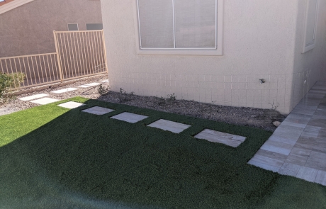 stone-stepping-path-on-artificial-turf.jpg Artificial turf lawn with stone stepping path leading to side yard.