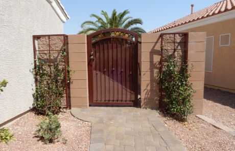 wrought-iron-gate-with-paver-entry.jpg Custom wrought iron gate with side trellises and stone paver walkway.