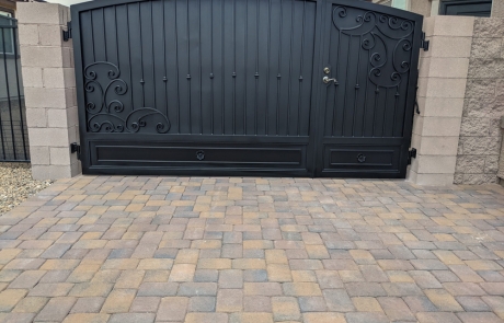 wrought-iron-gate-with-stone-paver-driveway.jpg Custom wrought iron gate with decorative paver driveway and stone wall accents.